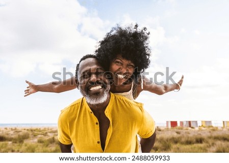 Image, Stock Photo a smiling middle aged woman in casual clothes in her fifties takes a selfie with her mobile phone against a cloudy sky, copy space