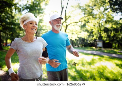 Beautiful Mature Couple Jogging In Nature Living Healthy