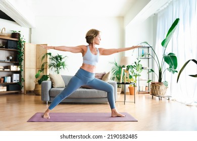 Beautiful mature senior woman at home, domestic life and leisure moments - 50-60 years old pretty female adult training in the living room - Shutterstock ID 2190182485
