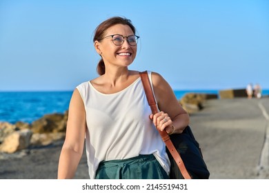 Beautiful Mature Woman With Backpack Walking Outdoor On Sea Travel Destination