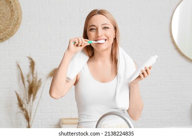 Beautiful mature woman  brushing teeth in bathroom