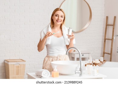 Beautiful Mature Woman  Brushing Teeth In Bathroom