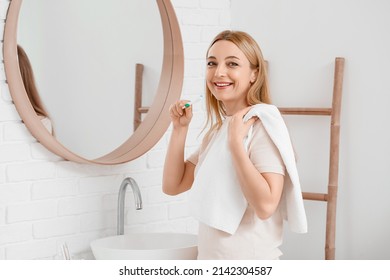 Beautiful Mature Woman  Brushing Teeth In Bathroom