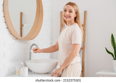 Beautiful Mature Woman  Brushing Teeth In Bathroom