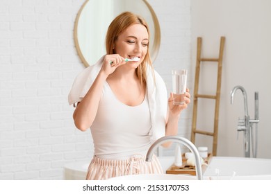 Beautiful Mature Woman  Brushing Teeth In Bathroom