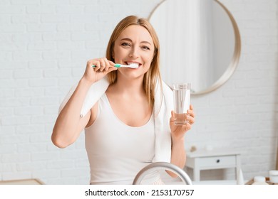 Beautiful Mature Woman  Brushing Teeth In Bathroom