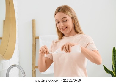 Beautiful Mature Woman  Brushing Teeth In Bathroom