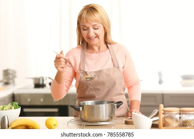 Beautiful Mature Woman Cooking In Kitchen