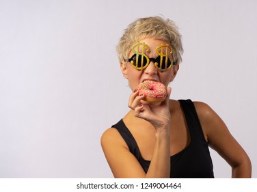 A Beautiful Mature Woman Is Eating Bright Donut.