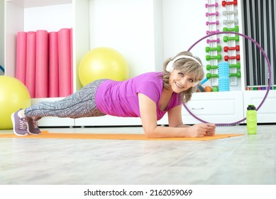 Beautiful Mature Woman Exercise Elbow Plank And Smile, In GYM, Fitness Concept, Horizontal Photo