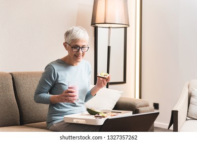 Beautiful Mature Woman With Glasses Eating Healthy Toast With Avocado And Fruit Yogurt, Healthy Lifestyle Concept