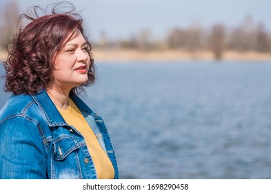 Beautiful Mature Woman On A Walking. A Nice Middle Aged Plus Size Woman Standing On The Street. Plump Women Lifestyle