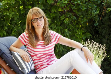 Beautiful Mature Woman Relaxing At Garden.