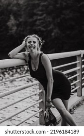 Beautiful Mature Woman With Shoes In Her Hands Walks In The Park