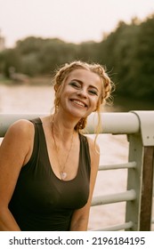 Beautiful Mature Woman With Shoes In Her Hands Walks In The Park