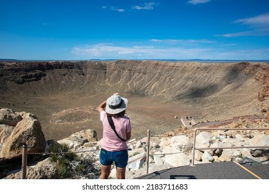 A Beautiful Mature Woman Taking A Picture Of Meteor Crater