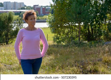 Beautiful Mature Woman Thinking Outdoors In Nature