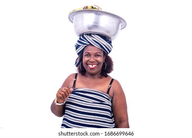 Beautiful Mature Woman In Traditional Dress Standing On White Background Carrying Banana Bowl And Looking At Camera Smiling.