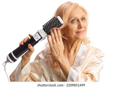 Beautiful Mature Woman Using A Hot Air Hair Brush Isolated On White Background