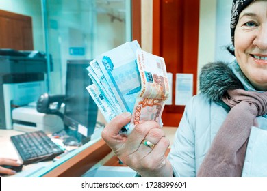 beautiful mature women received cash at Sberbank of Russia. Text in Russian: Bank of Russia ticket