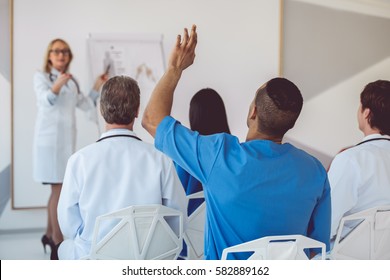 Beautiful Medical Doctor Is Giving Lecture For Her Colleagues Using A Whiteboard And Schemes