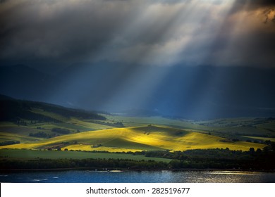 Beautiful meditative landscape with a sun rays comming from a cloud above water.