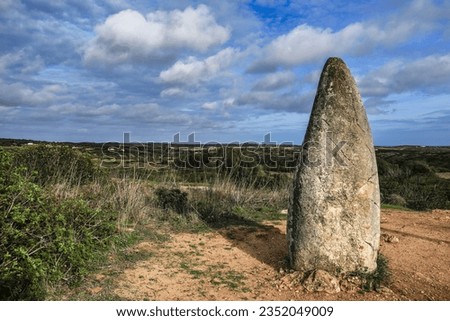 Beautiful Menhir do Padrao surrounded by vegetation in Vila do Bispo, Portugal