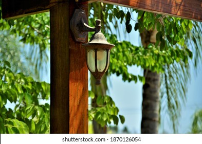 Beautiful Metal Sconce In Wooden Gazebo In The Yard