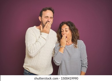 Beautiful middle age couple wearing winter sweater over isolated purple background bored yawning tired covering mouth with hand. Restless and sleepiness. - Shutterstock ID 1500419990