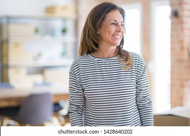 Beautiful middle age senior woman standing looking away to side with smile on face, natural expression. Laughing confident. - Powered by Shutterstock