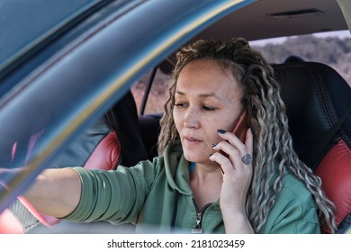 Beautiful Middle Aged Asian Woman Sitting In A Car Talking On The Phone. Close-up