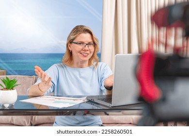 Beautiful middle aged blond woman making financial, investment or saving money content. Blogger creating content for social media. finance advisor management information - Shutterstock ID 2258260501