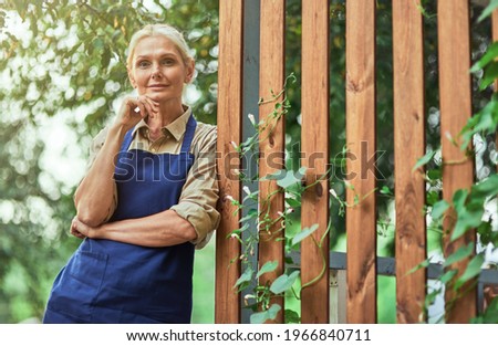 Beautiful middle aged caucasian business woman near fence