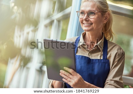 Beautiful middle aged caucasian woman with tablet