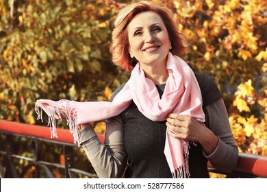 Beautiful Middle Aged Woman In Autumn Park