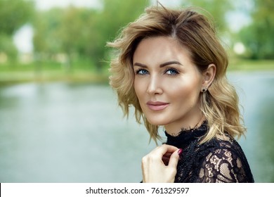 Beautiful Middle Aged Woman Having A Rest At A Park On A Summer Day. Mood Of Summer And Carefree Vacations. Beauty, Cosmetics.