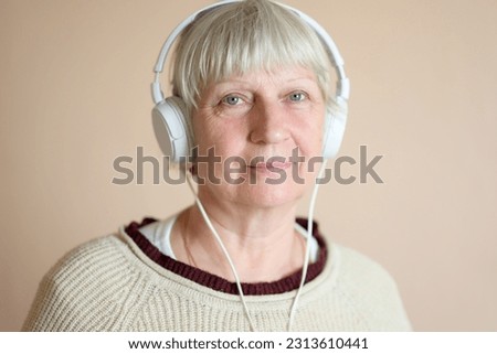 Beautiful middle aged woman with headphones at home.
