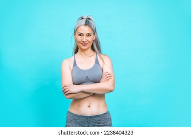 beautiful middle aged woman making sport at the gym.  female model posing for a body positive and self acceptance concept photoshooting on colored backgrounds - Shutterstock ID 2238404323