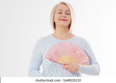 Beautiful Middle Aged Woman With Menopause Blowing By Fan. Hormone Replacement Therapy And Mature Woman Healthcare. Mid Age Happy Women Lifestyle. Senior Woman Isolated On White Background