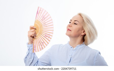 Beautiful Middle Aged Woman With Menopause Blowing By Fan. Hormone Replacement Therapy And Mature Woman Healthcare. Mid Age Happy Women Lifestyle. Senior Woman Isolated On White. Selective Focus.