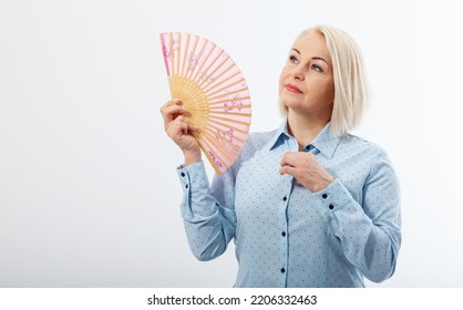 Beautiful Middle Aged Woman With Menopause Blowing By Fan. Hormone Replacement Therapy And Mature Woman Healthcare. Mid Age Happy Women Lifestyle. Senior Woman Isolated On White Background