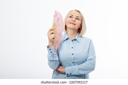 Beautiful Middle Aged Woman With Menopause Blowing By Fan. Hormone Replacement Therapy And Mature Woman Healthcare. Mid Age Happy Women Lifestyle. Senior Woman Isolated On White Background