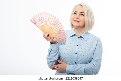 Beautiful Middle Aged Woman With Menopause Blowing By Fan. Hormone Replacement Therapy And Mature Woman Healthcare. Mid Age Happy Women Lifestyle. Senior Woman Isolated On White Background