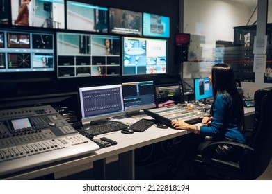 Beautiful middle aged beautiful woman working on a tv station as a producer in a broadcast control room. Show production maker. Television. - Shutterstock ID 2122818194