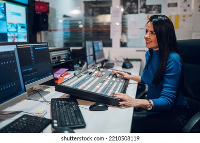 Beautiful Middle Aged Beautiful Woman Working On A Tv Station As A Producer In A Broadcast Control Room. Show Production Maker. Television. Focus On A Beautiful Woman Smiling While Working.