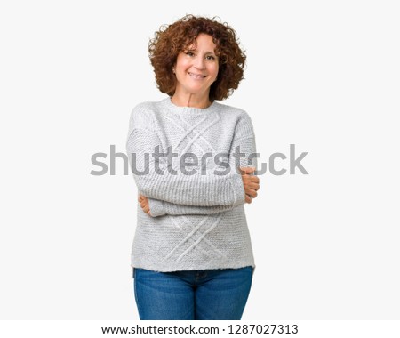Beautiful middle ager senior woman wearing winter sweater over isolated background happy face smiling with crossed arms looking at the camera. Positive person.