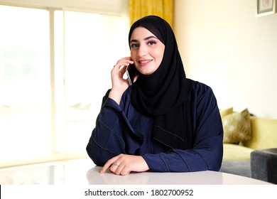 Beautiful Middle East Arab Woman Calling. Arabic Lady Calls On Smart Mobile Phone Ideal For Telecommunication Or Banking Concept. Emirati Female National Talks From Cellphone