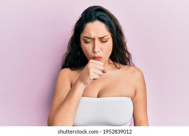 Beautiful Middle Eastern Woman Standing Wearing A Top Showing Skin Feeling Unwell And Coughing As Symptom For Cold Or Bronchitis. Health Care Concept. 