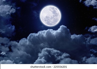 Beautiful Midnight Sky With Bright Full Moon And Stars Above Clouds