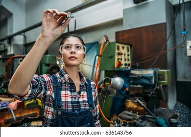 Beautiful Milling Machine Female Staff Wearing Safety Goggles Focus On Components Finished Product Standing In Front Of Technology Machine.